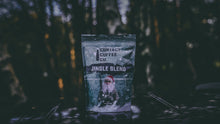 Load image into Gallery viewer, Jingle Blend festive coffee bag in a dark Christmas scene
