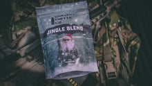 Load image into Gallery viewer, Jingle Blend Christmas coffee bag styled in dark festive foliage
